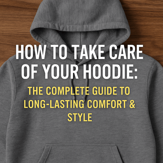 Flat lay of a gray hoodie on a wooden surface with bold text overlay that reads "How to Take Care of Your Hoodie: The Complete Guide to Long-Lasting Comfort & Style." Ideal image for a blog post on hoodie care and washing tips