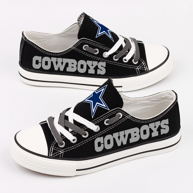 Side view of two Dallas Cowboys canvas sneakers, highlighting the large 'COWBOYS' text print and the team star logo on the tongue