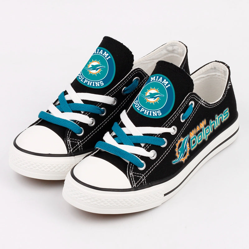 Two black low-top canvas shoes featuring the Miami Dolphins logo, ideal for game day or casual streetwear looks