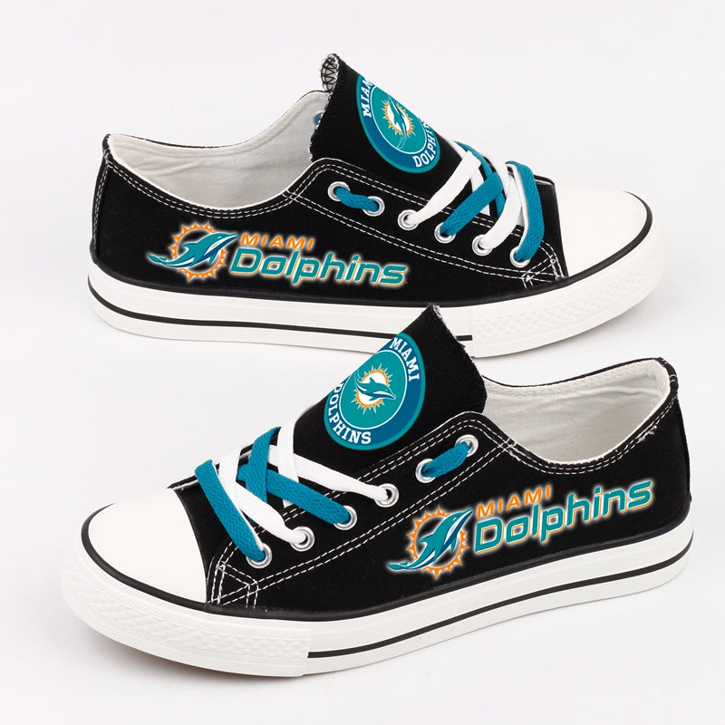 Black canvas shoes decorated with Miami Dolphins logos and teal shoelaces, perfect for fans who love sporty style and comfort