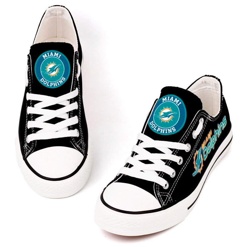 A top view of black canvas sneakers with Miami Dolphins branding, white laces, and clean stitching, designed for comfort and team pride.
