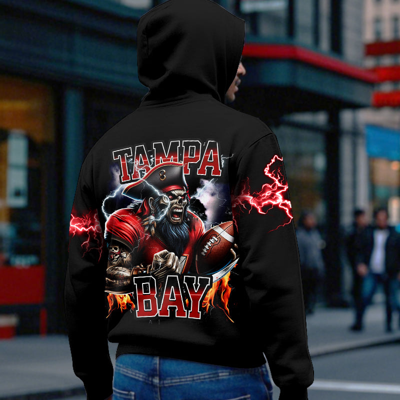 Back view of the Tampa Bay Buccaneers hoodie featuring a fierce pirate graphic holding a football, surrounded by flames and red lightning, symbolizing team pride and power.