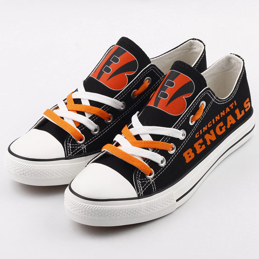 Pair of black Cincinnati Bengals canvas low-top shoes with orange and white laces. Features the "B" helmet logo and bold orange 'BENGALS' text. Ideal NFL fan gear.
