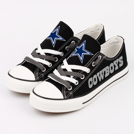 Close-up shot of two Dallas Cowboys custom fan sneakers with black canvas, white toe cap, and contrasting grey and white laces.