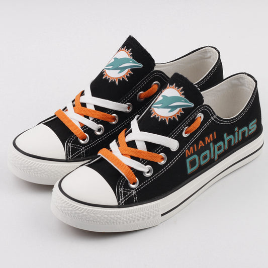 Pair of black Miami Dolphins canvas sneakers with alternating teal and white laces. Close-up view of the team logo and colors.