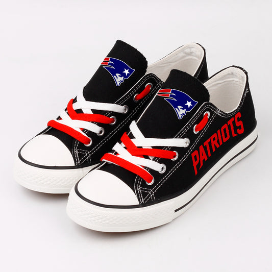 Pair of black New England Patriots canvas low-top shoes with red and white laces. Features the "Flying Elvis" logo and bold red "PATRIOTS" lettering.