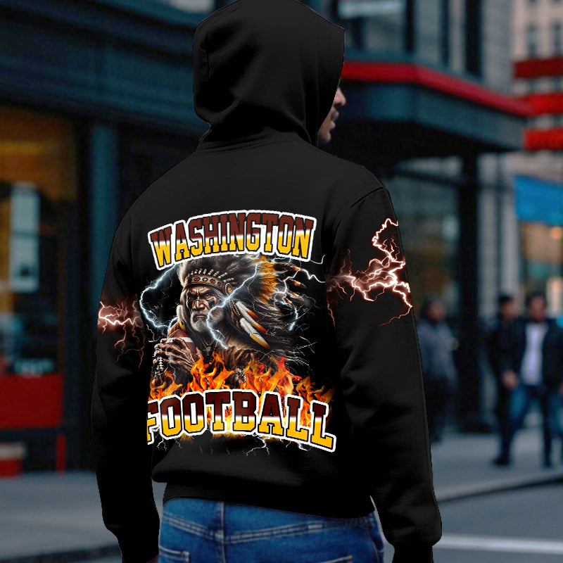 Back view of a fan wearing a black Washington Redskins hoodie showing a detailed warrior/chief graphic holding a football, surrounded by flames and lightning. Must-have Redskins Football Gear.